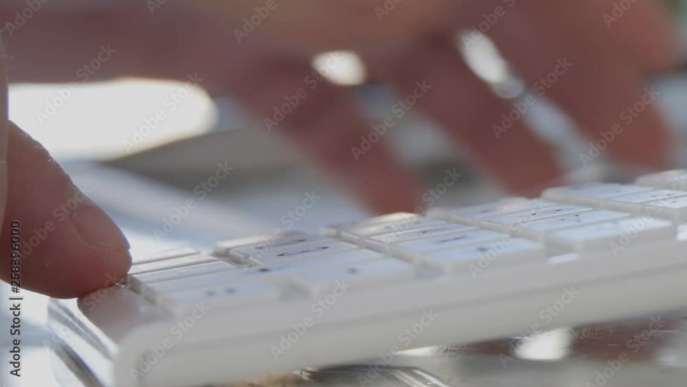 Man Take Eye Glasses from Table and Make Calculation using Adding Machine Man Take Eye Glasses from Table and Make Calculation using Adding Machine