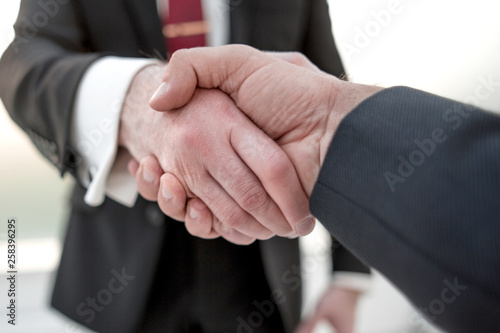 close up.handshake business partners.