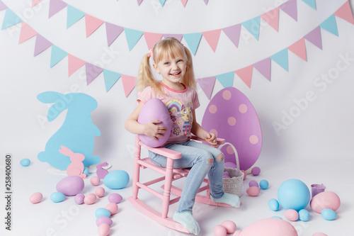Cute  girl with Easter eggs on white background. Girl play with eggs.  Easter colored eggs
