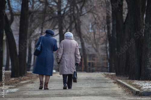 older women are walking down the street