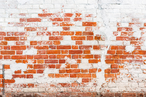Background of old vintage brick wall with peeling plaster, texture
