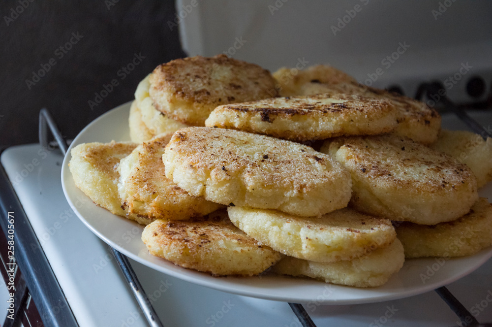 Hot tasty baked cheese pancakes in the plate standing on the gas stove. Breakfast Hot tasty baked cheese pancakes in the plate standing on the gas stove. Breakfast