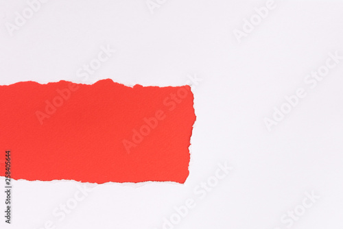 White torn paper over red background