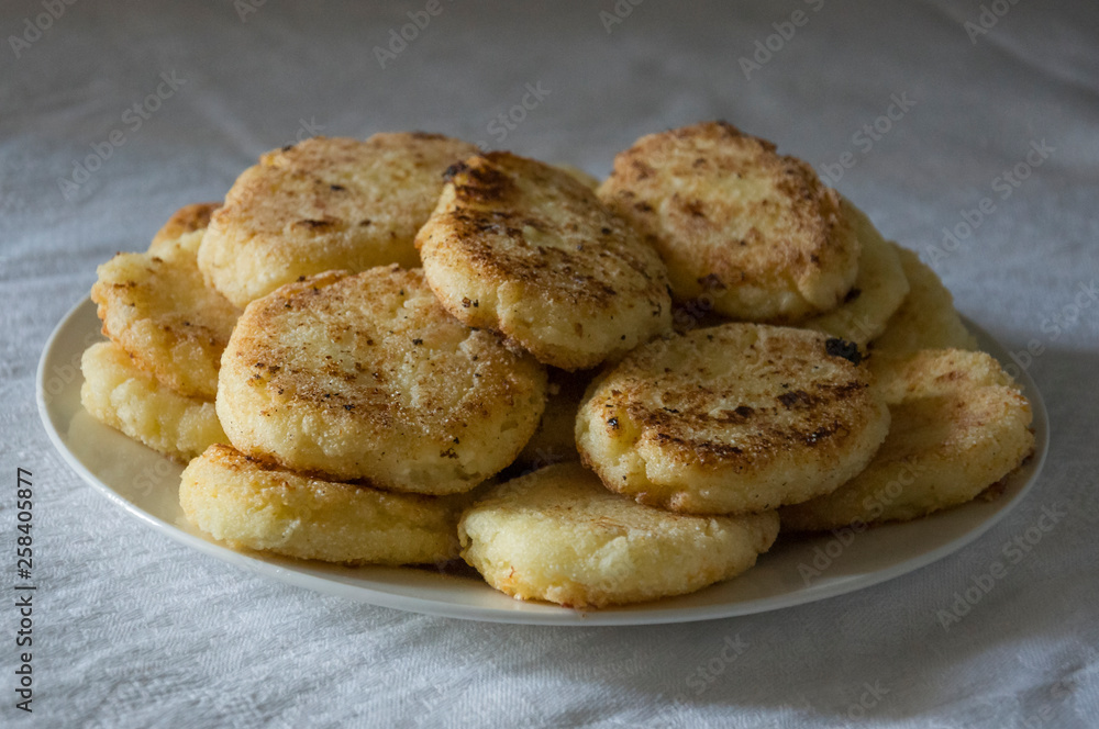 Hot tasty baked cheese pancakes in the plate standing on the gas stove. Breakfast Hot tasty baked cheese pancakes in the plate standing on the gas stove. Breakfast