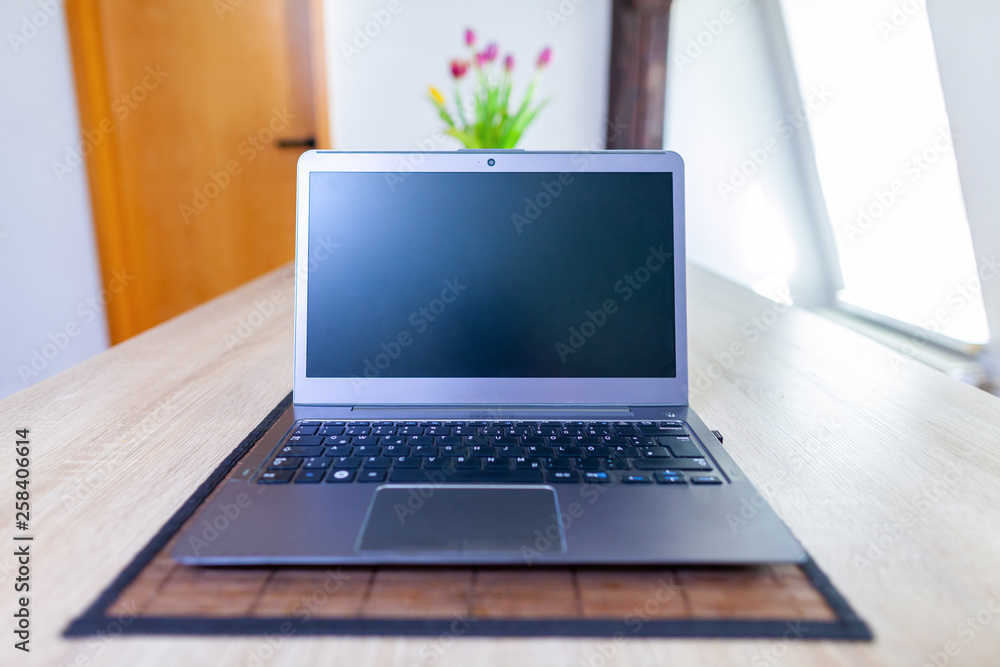 A clean laptop stands on a table A clean laptop stands on a table