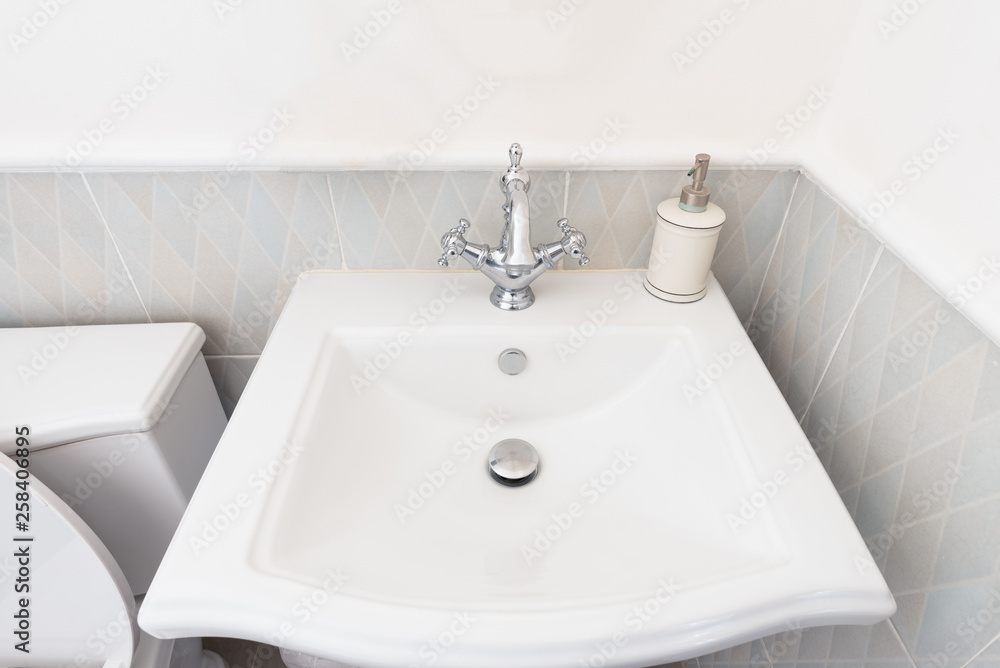 White luxury sink in bathroom, Modern hygienic wash basin with running clean water. White luxury sink in bathroom, Modern hygienic wash basin with running clean water.