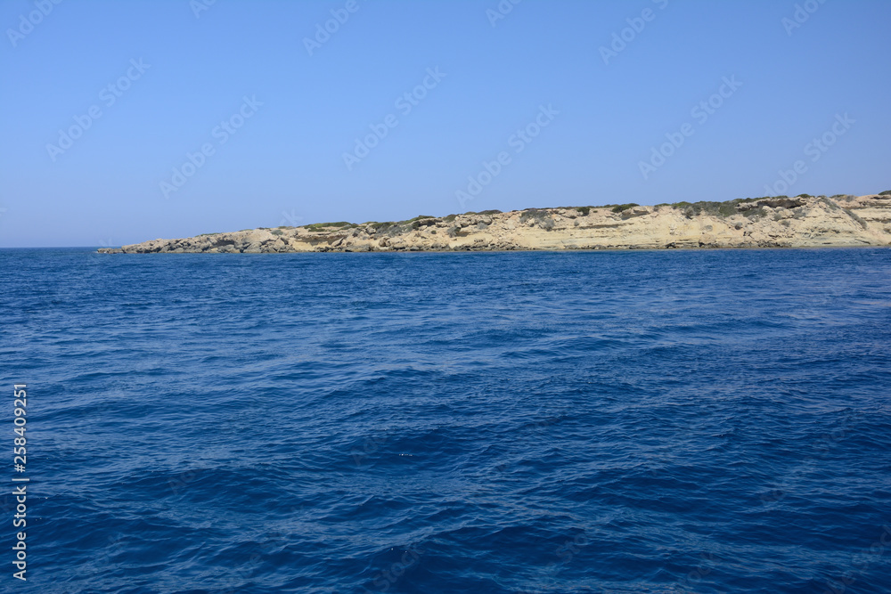 view from the sea on the rocky coast