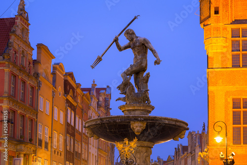 Beautiful architecture of the old town in Gdansk with Neptune fountain at dawn, Poland