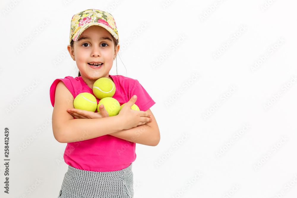Brunette little girl with a tennis racket isolated on a over white background Brunette little girl with a tennis racket isolated on a over white background