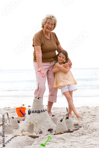 Grand mother and grand daughter on the beach