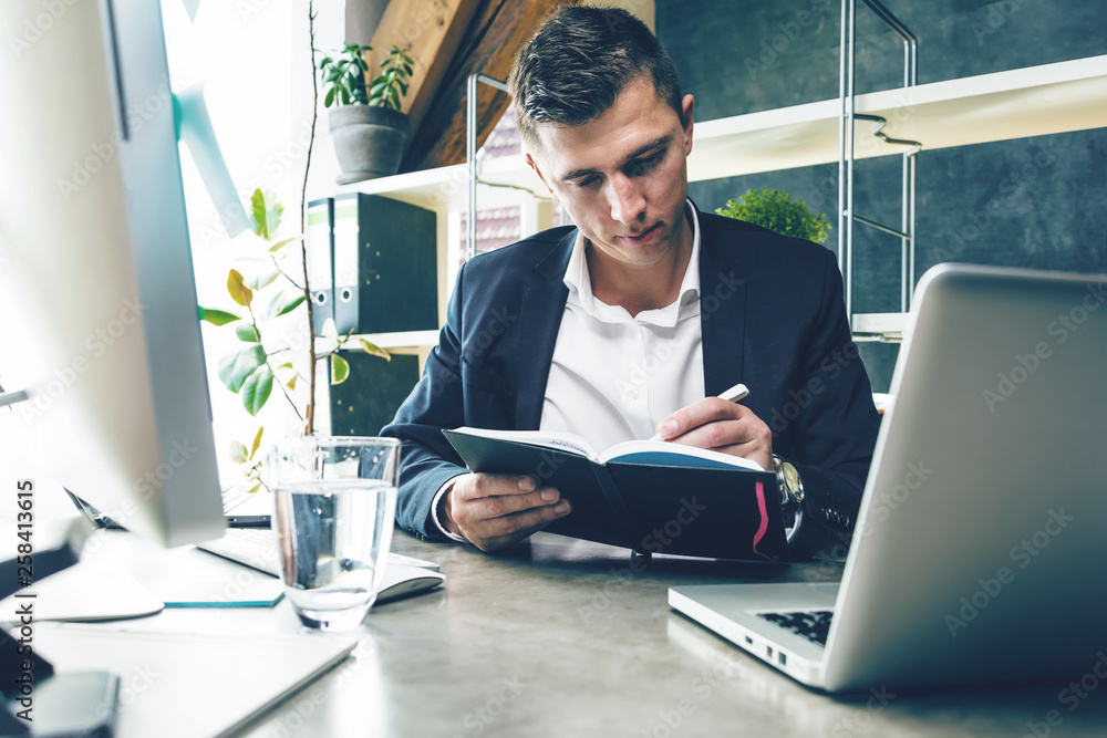 Business man working at office with laptop and documents on his desk Business man working at office with laptop and documents on his desk