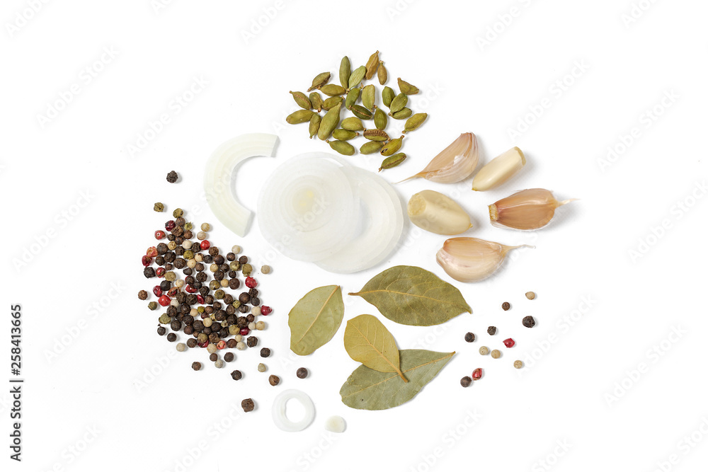 Mix of seasonings from onion, bay leaf, coriander, garlic, black pepper on a white background Mix of seasonings from onion, bay leaf, coriander, garlic, black pepper on a white background