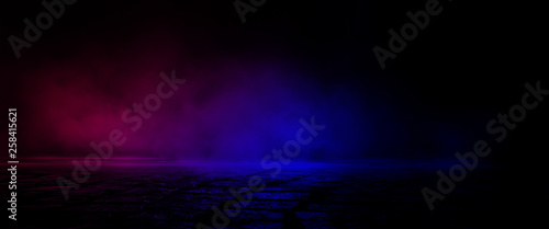 Wet asphalt, reflection of neon lights, a searchlight, smoke. Smoke, smog. Dark background scene of empty street, night view, night city. Neon red and blue light.