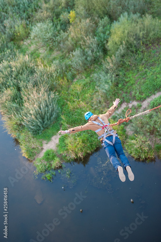 Extreme jump from the bridge. The man jumps surprisingly quickly in bungee jumping at Sky Park explores extreme fun. Bungee in the canyon.