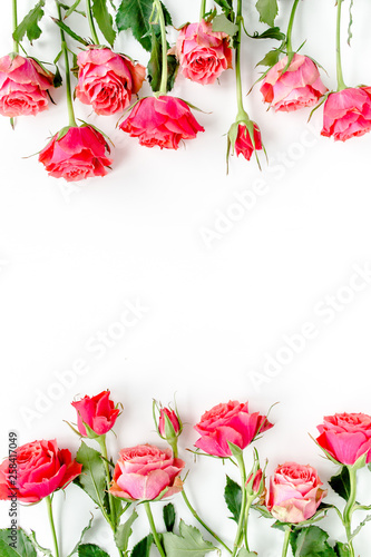 Fototapeta Naklejka Na Ścianę i Meble -  Flower border frame made of red roses on white background with copy space for text. Valentine's background. Floral pattern. Flat lay, top view. 