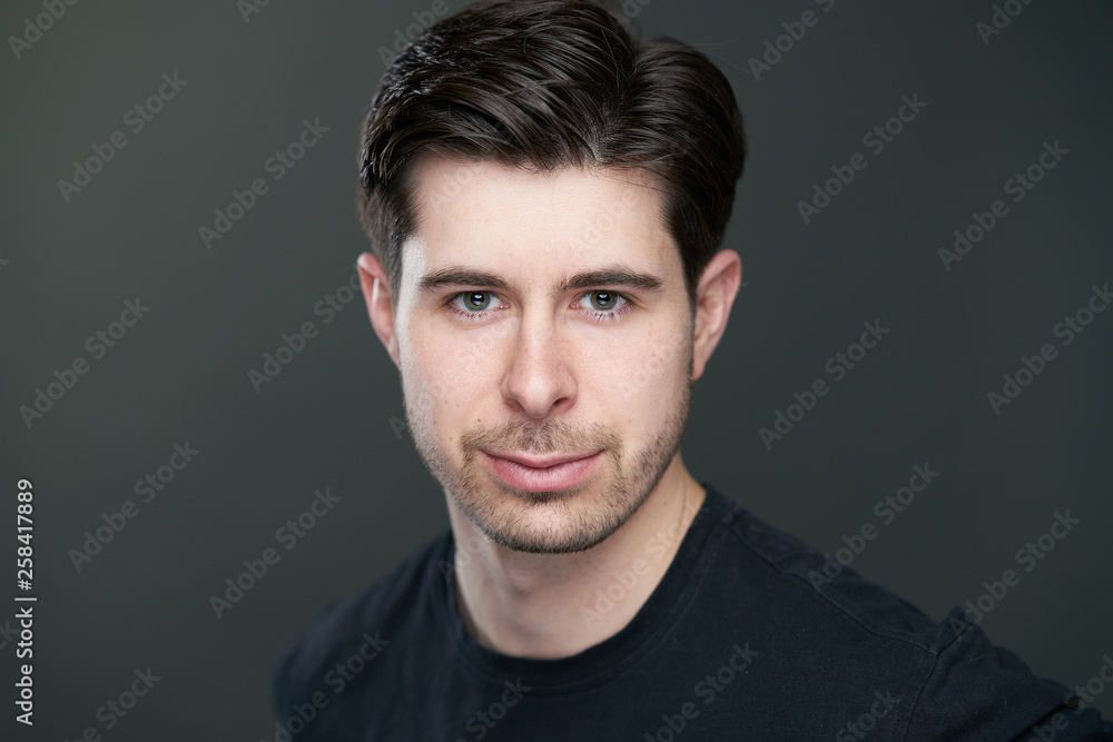 Portait of handsome man with short black hair in studio, caucasian Portait of handsome man with short black hair in studio, caucasian