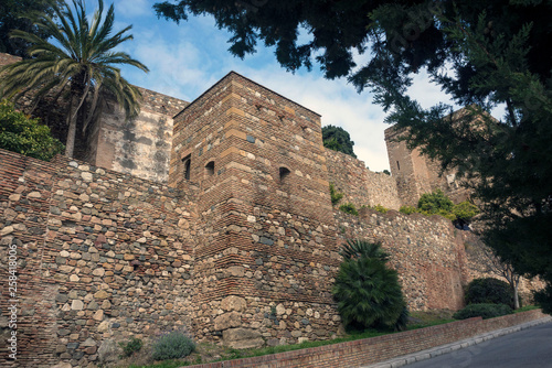 The fortress of Alcazaba (Alcazaba de M?laga) is an Arab fortification on Mount Gibralfaro in Spanish Malaga. Powerful brick walls of the fortress of Malaga on a warm sunny day.