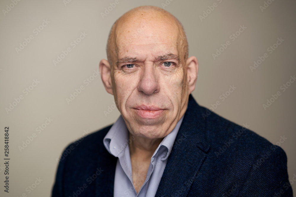 Bald caucasian man with shirt jacket and tie in studio Bald caucasian man with shirt jacket and tie in studio