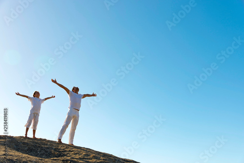 Father and son breathing on top of hill