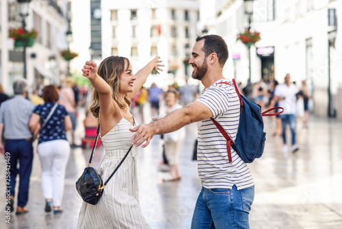 Spain, Andalusia, Malaga, happy couple hugging in the city photo