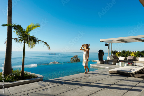 Young woman walking by the swimming pool