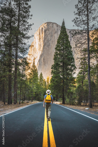 USA, California, Yosemite National Park, man walking on road with El Capitan in background