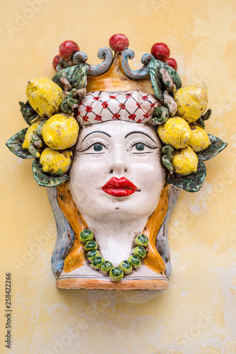 Fototapeta Naklejka Na Ścianę i Meble -  A typical ceramic of Sicily hung along the streets of Ragusa Ibla - Vase Head Moor Ceramic Lady