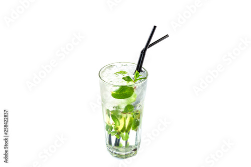 Mojito with lime and mint in a tall glass cup with a straw on an isolated white background