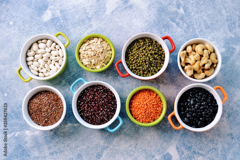 Red lentils, peas, black, white and red beans, nuts - the concept of healthy vegetarian food. Top view. Red lentils, peas, black, white and red beans, nuts - the concept of healthy vegetarian food. Top view.