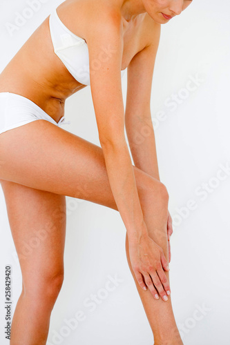 Female applying skin cream