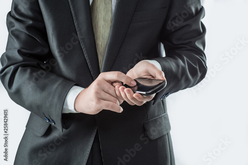 close up. businessman typing SMS on smartphone