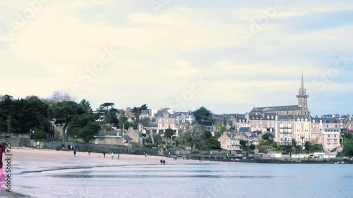 Rocky coast at the beach of Dinard vith the views of Dinard old town and Saint Malo at the low tide time photo