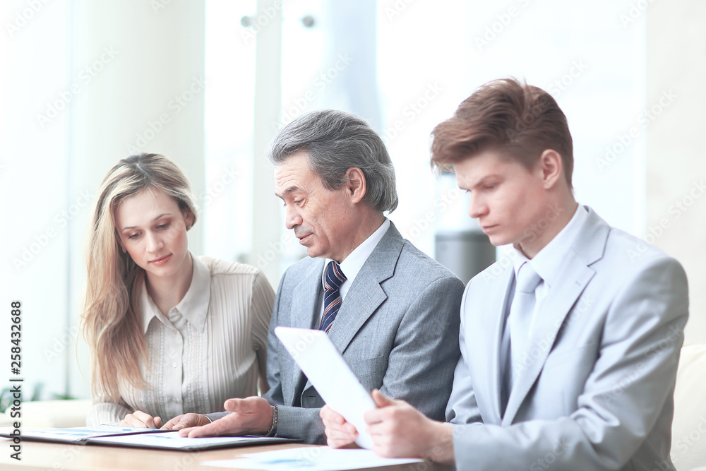 smiling business team checking financial data.photo with copy space smiling business team checking financial data.photo with copy space