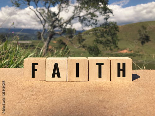 Religious concept - FAITH written on wooden blocks. photo