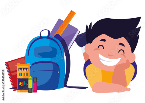 happy little schoolboy with schoolbag and supplies