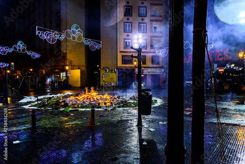 Valencia, Spain - March 19, 2019: Remains of a fire in the street during the night. photo