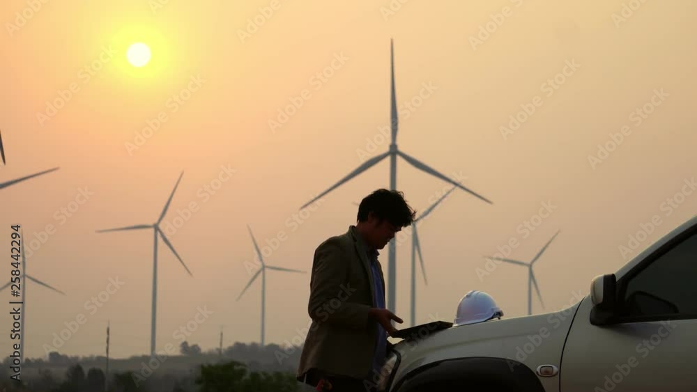 Senior Engineer, Asian are monitoring system wind turbine electricity generation with teblet footage 4K Senior Engineer, Asian are monitoring system wind turbine electricity generation with teblet footage 4K