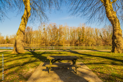 Wooden table with benches for picnic in front of the Seine River, Bray-sur-Seine