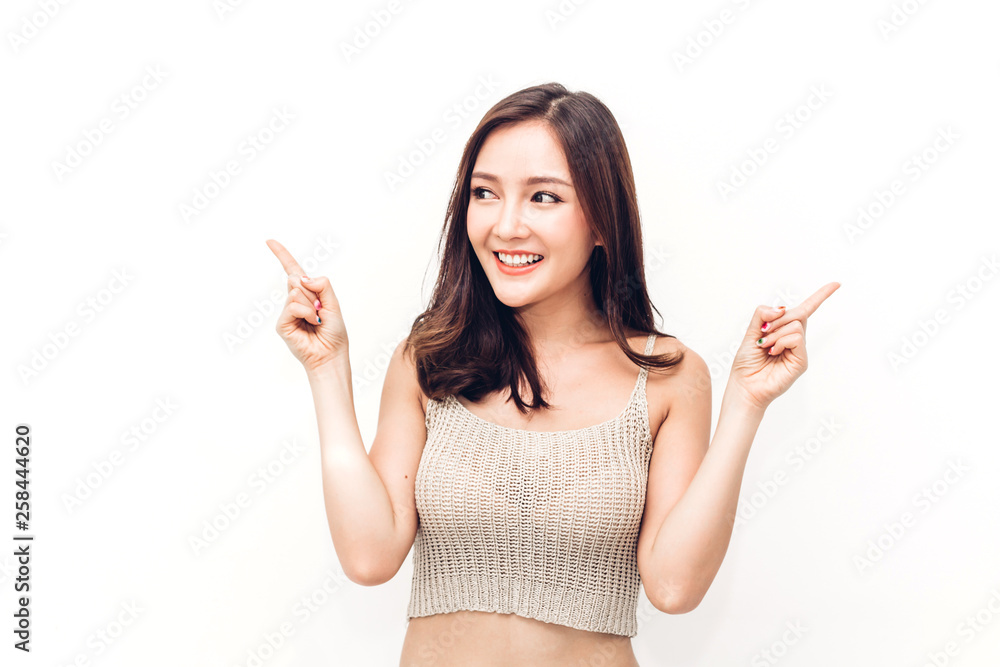 Portrait of happy smiling asian young woman pointing to empty copy space isolated on white background Portrait of happy smiling asian young woman pointing to empty copy space isolated on white background