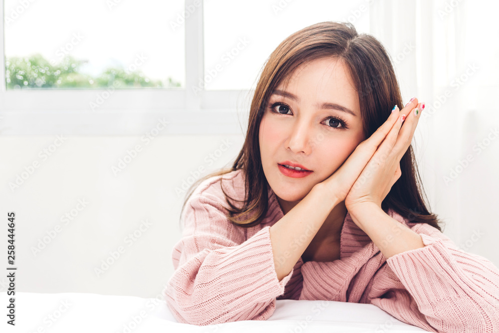 Portrait of happy smile asia woman enjoy and relax on the bed in bedroom at home.asian beauty Portrait of happy smile asia woman enjoy and relax on the bed in bedroom at home.asian beauty