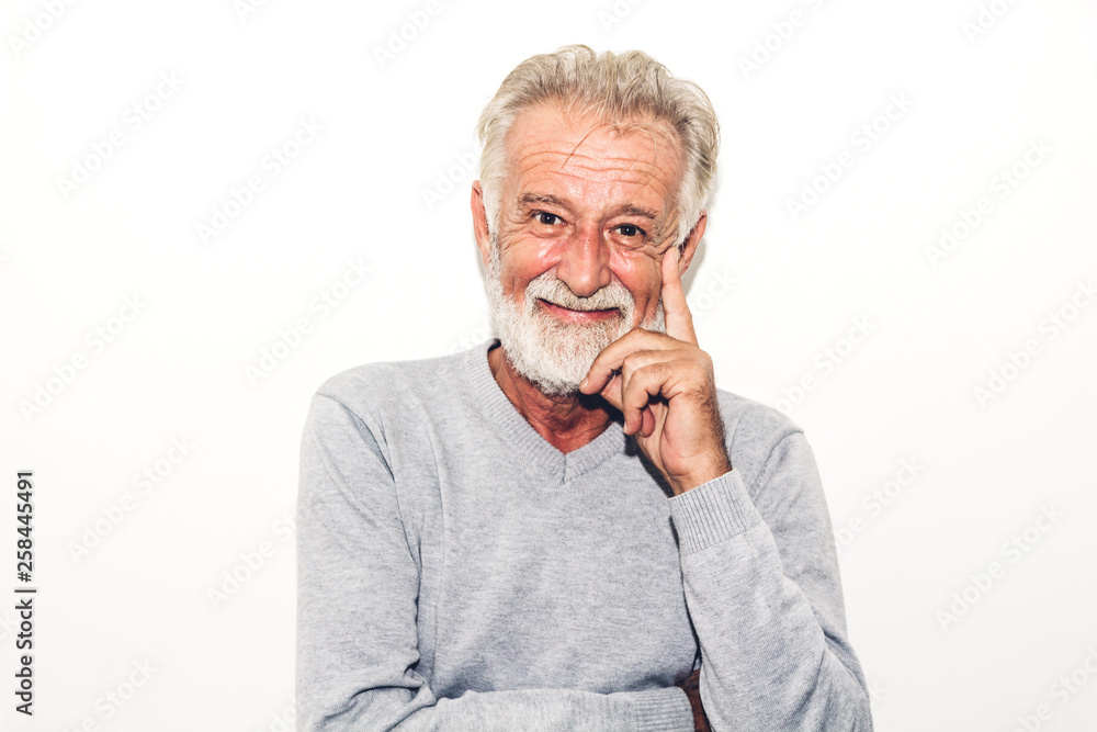 Portrait of happy smiling senior man looking at camera while standing on white background Portrait of happy smiling senior man looking at camera while standing on white background