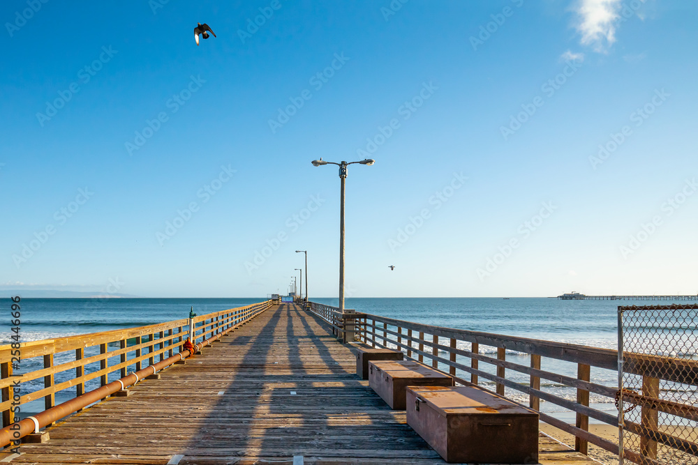 Long Wooden Pier and Blue Sky, Sunny Day in Avila Beach, California