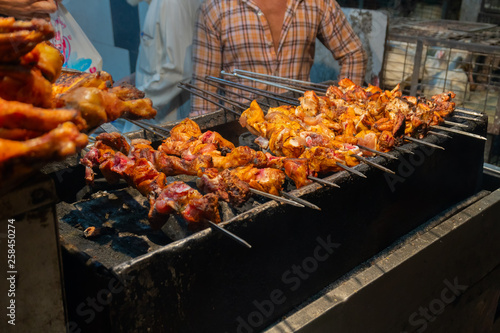 Chicken seekh kababs are being prepared road side