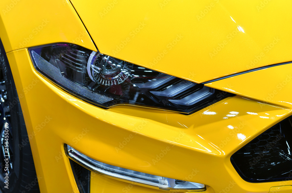 Detail on one of the LED headlights yellow car.