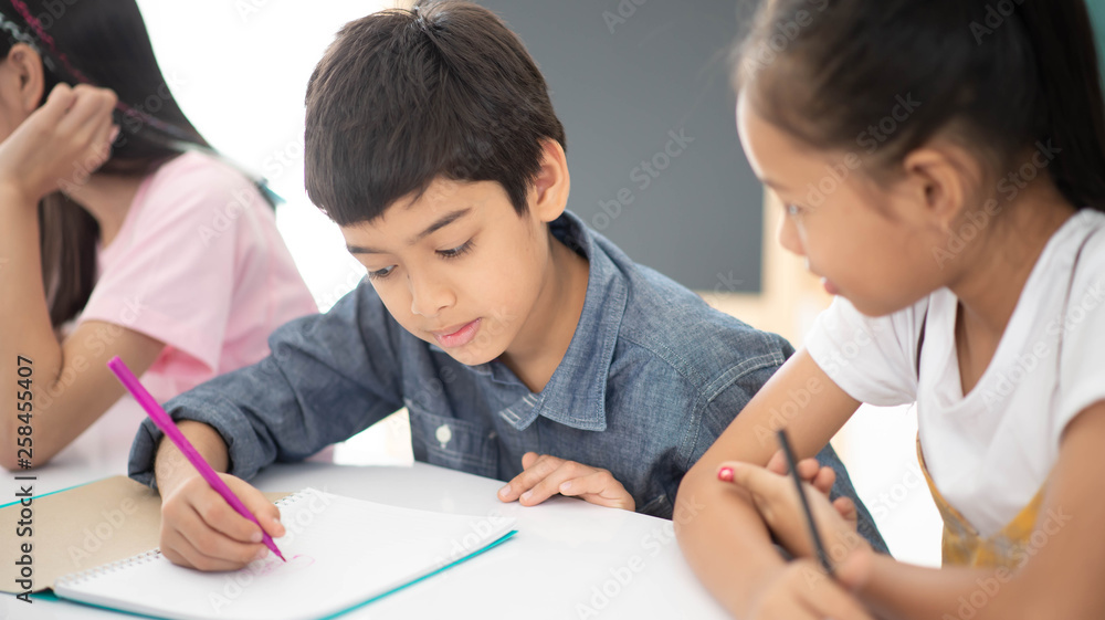 Asian primary student and teacher in the classroom Asian primary student and teacher in the classroom