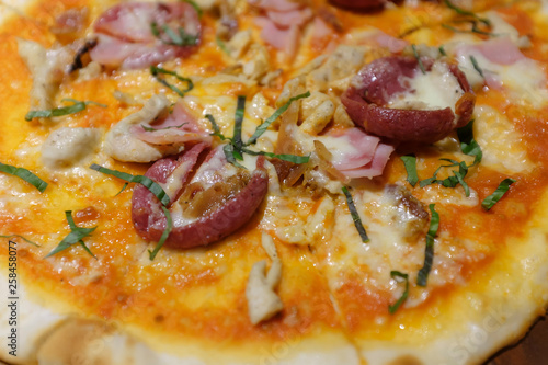 close up pizza slice topping with sausage, cheese and onion