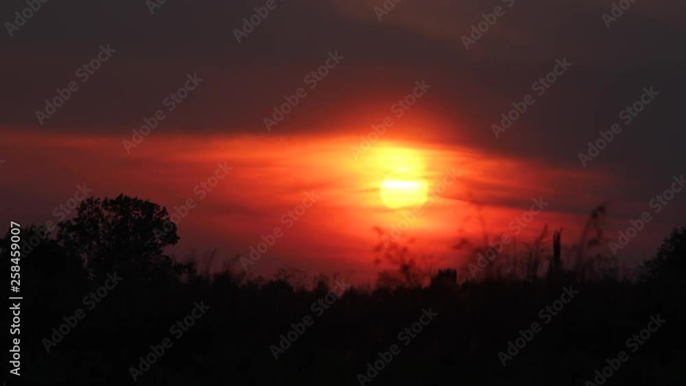 sunset timelapse on a large meadow with slow camera pan sunset timelapse on a large meadow with slow camera pan
