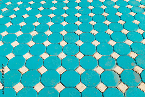 Footpath made by square blue tiles with illusional perspective
