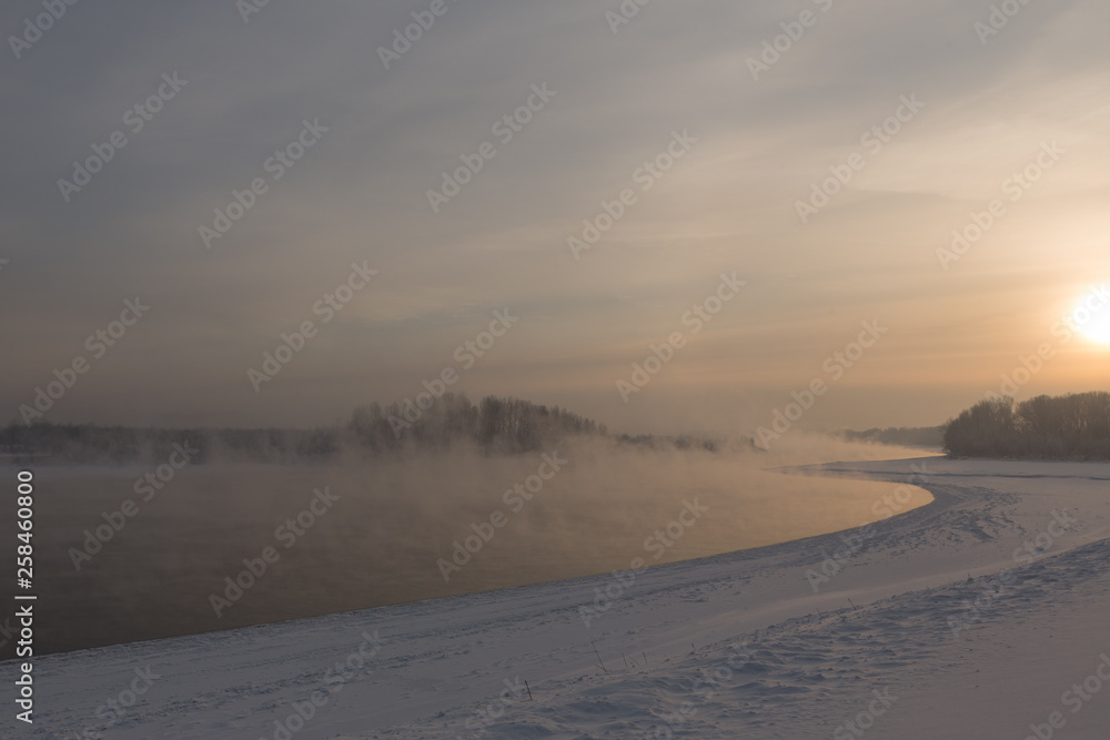winter frosty sunset on the river in Siberia in winter winter frosty sunset on the river in Siberia in winter