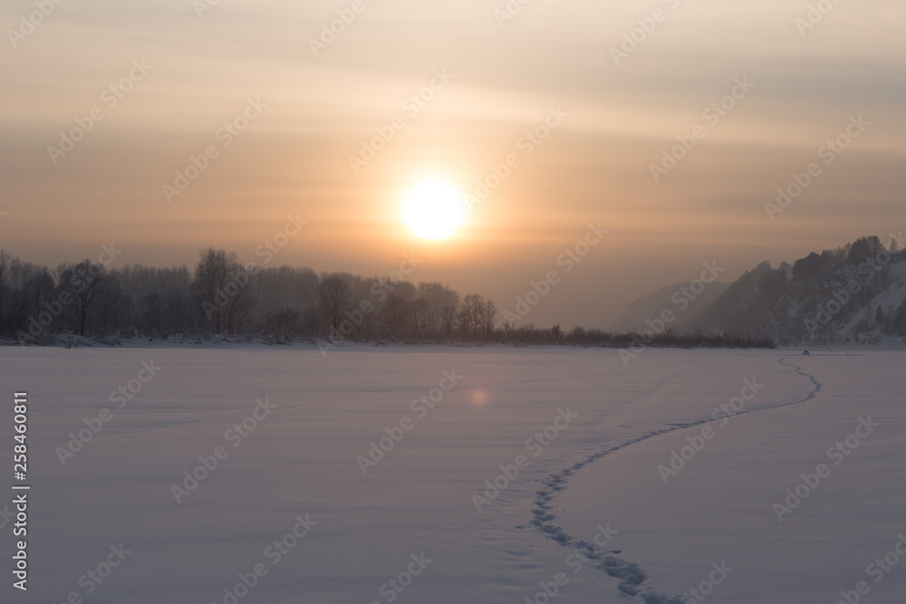 winter frosty sunset on the river in Siberia in winter winter frosty sunset on the river in Siberia in winter